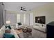 Cozy living room with a ceiling fan, white furniture, and modern television at 3405 10Th W St, Palmetto, FL 34221