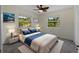 Cozy bedroom with a plush bed, two side tables, and large windows providing ample natural light at 3405 10Th W St, Palmetto, FL 34221