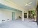 Covered patio featuring multiple ceiling fans, a door, and a view to fenced yard at 3405 10Th W St, Palmetto, FL 34221