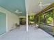 View of the partially covered outdoor patio featuring ceiling fans and screening at 3405 10Th W St, Palmetto, FL 34221