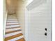 Staircase featuring hardwood treads, painted risers, and white trim leading to upper levels at 3405 10Th W St, Palmetto, FL 34221