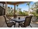 Outdoor balcony featuring a patio set with seating for four, offering tranquil views of lush tropical foliage at 436 Canal Rd # A, Sarasota, FL 34242