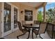 Covered balcony with outdoor seating, overlooking a lush landscape with palm trees, providing a serene outdoor escape at 436 Canal Rd # A, Sarasota, FL 34242