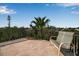 Balcony with outdoor seating overlooking lush tropical trees and blue skies at 436 Canal Rd # A, Sarasota, FL 34242