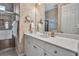 Well-lit bathroom with a spacious vanity, mirrored wall, and shower with patterned wall coverings at 436 Canal Rd # A, Sarasota, FL 34242