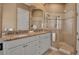 Elegant bathroom featuring a double vanity with granite countertops and a glass shower at 436 Canal Rd # A, Sarasota, FL 34242