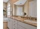 Bright bathroom with a double vanity, tub, and neutral tile at 436 Canal Rd # A, Sarasota, FL 34242