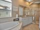 Luxurious bathroom featuring a soaking tub, double vanity, and a separate glass-enclosed shower at 436 Canal Rd # A, Sarasota, FL 34242