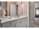 Well-lit bathroom with a spacious vanity, mirrored wall, and patterned wall coverings at 436 Canal Rd # A, Sarasota, FL 34242