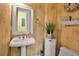 Vintage style bathroom featuring a pedestal sink, decorative wallpaper, and charming details, offering a unique aesthetic at 436 Canal Rd # A, Sarasota, FL 34242