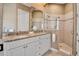 Elegant bathroom with a double vanity, granite countertops, and a glass-enclosed shower at 436 Canal Rd # A, Sarasota, FL 34242