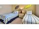 This bedroom is styled with dual twin beds, beach-themed decor, and lots of natural light at 436 Canal Rd # A, Sarasota, FL 34242