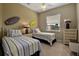 This bedroom is styled with dual twin beds, beach-themed decor, and lots of natural light at 436 Canal Rd # A, Sarasota, FL 34242