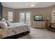 Comfortable bedroom with a ceiling fan, white dresser, and access to a balcony at 436 Canal Rd # A, Sarasota, FL 34242