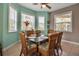 Bright dining room features a glass-top table and wicker chairs, with natural light streaming through large windows at 436 Canal Rd # A, Sarasota, FL 34242