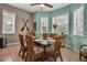 Bright dining room features a glass-top table and wicker chairs, complemented by natural light from multiple windows at 436 Canal Rd # A, Sarasota, FL 34242