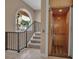 Easy accessibility offered by a wooden elevator, situated by a stairway and arched window, offers convenience and style at 436 Canal Rd # A, Sarasota, FL 34242