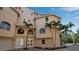 Exterior corner view of a beige three-story home showing the entrance and multiple arched windows at 436 Canal Rd # A, Sarasota, FL 34242