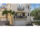 Beige three-story home featuring multiple balconies, a ground-level patio and a garage at 436 Canal Rd # A, Sarasota, FL 34242