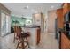 Open-concept kitchen with a breakfast bar, dark countertops, and views of the living area for easy entertaining at 436 Canal Rd # A, Sarasota, FL 34242