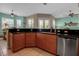 Well-appointed kitchen with dark granite countertops, stainless steel dishwasher, and access to a bright dining area at 436 Canal Rd # A, Sarasota, FL 34242
