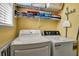 Convenient laundry area featuring a white washer and dryer, with shelving for storage at 436 Canal Rd # A, Sarasota, FL 34242