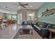 Open living space with sofas, tiled floor, and view into the dining room for seamless entertaining and living at 436 Canal Rd # A, Sarasota, FL 34242