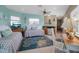 Open living room area with kitchenette, twin beds, tile floor, and relaxing colors at 436 Canal Rd # A, Sarasota, FL 34242