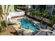 Aerial view of the backyard pool, surrounded by lounge chairs and Gathering having fun on a sunny day at 436 Canal Rd # A, Sarasota, FL 34242