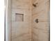 Shower stall featuring decorative tilework and built-in storage niche at 436 Canal Rd # A, Sarasota, FL 34242