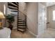 Elegant spiral staircase featuring carpeted steps and a wrought iron railing at 436 Canal Rd # A, Sarasota, FL 34242