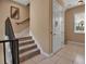 Carpeted staircase with metal railings leads to the next level, complemented by a convenient elevator and natural light at 436 Canal Rd # A, Sarasota, FL 34242