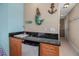 Attractive wet bar featuring granite countertop, refrigerator, and wood cabinetry at 436 Canal Rd # A, Sarasota, FL 34242
