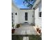 Backyard patio with tile, well-lit entrance, and decorative potted plants at 4704 Winchester Dr, Sarasota, FL 34234