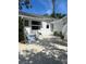 Backyard features a patio, blue stairs, and manicured landscaping, perfect for outdoor living at 4704 Winchester Dr, Sarasota, FL 34234