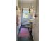 Charming bathroom featuring beadboard walls, pedestal sink, and a shower with stylish curtain at 4704 Winchester Dr, Sarasota, FL 34234