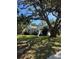 Quaint one-story home with a tidy lawn, complemented by the mature trees providing shade and natural beauty at 4704 Winchester Dr, Sarasota, FL 34234