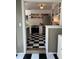Charming kitchen featuring modern appliances, gray cabinetry, and checkerboard flooring at 4704 Winchester Dr, Sarasota, FL 34234