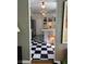 Sunlit kitchen featuring checkered floors, white cabinetry, and stainless steel appliances at 4704 Winchester Dr, Sarasota, FL 34234