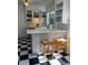 Charming eat-in kitchen featuring a black and white floor with stools at the countertop at 4704 Winchester Dr, Sarasota, FL 34234