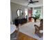 Bright living room featuring a decorative mirror, pendant lighting, and ample sunlight at 4704 Winchester Dr, Sarasota, FL 34234