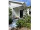 Inviting porch with wrought iron accents, potted plants, and well-maintained steps leading to the entrance at 4704 Winchester Dr, Sarasota, FL 34234