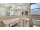 Bathroom vanity featuring large mirror, bowl sink, and ample storage space at 4861 Waterbridge Down, Sarasota, FL 34235