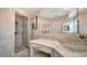 Bathroom with glass shower enclosure, vanity with glass bowl sink and storage at 4861 Waterbridge Down, Sarasota, FL 34235