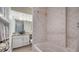 Bathroom with jacuzzi tub and double sink vanity with granite countertop at 4861 Waterbridge Down, Sarasota, FL 34235