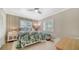 Cozy bedroom with tropical wallpaper, shutters, and natural light at 4861 Waterbridge Down, Sarasota, FL 34235