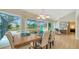 Bright dining room with sliding glass doors and views of the screened-in lanai and pool at 4861 Waterbridge Down, Sarasota, FL 34235