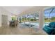 Bright dining room with sliding glass doors and views of the screened-in lanai and pool at 4861 Waterbridge Down, Sarasota, FL 34235