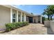 Inviting entrance showcasing a patterned brick paver patio and lush landscaping at 4861 Waterbridge Down, Sarasota, FL 34235