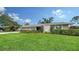 Charming home displaying a manicured lawn, neat hedges, and a well-maintained exterior at 4861 Waterbridge Down, Sarasota, FL 34235